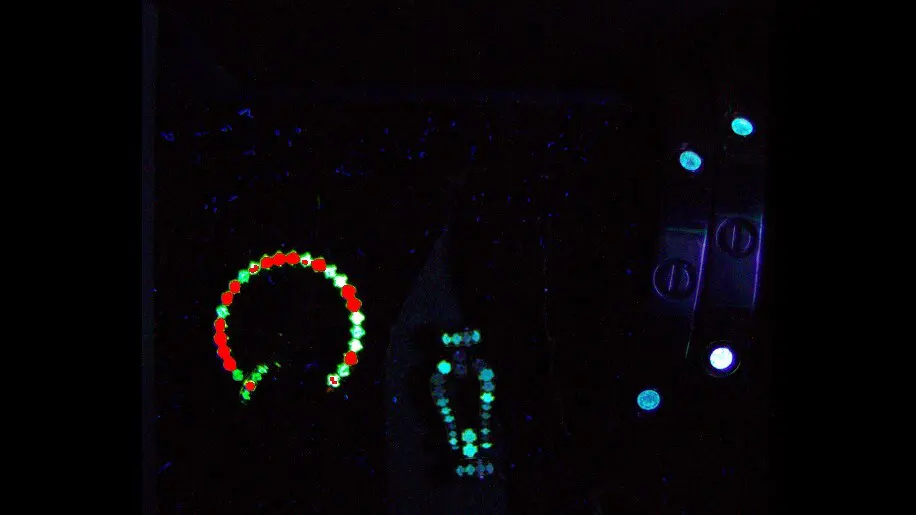 Jewelry under UV light showing fluorescence patterns during authentication