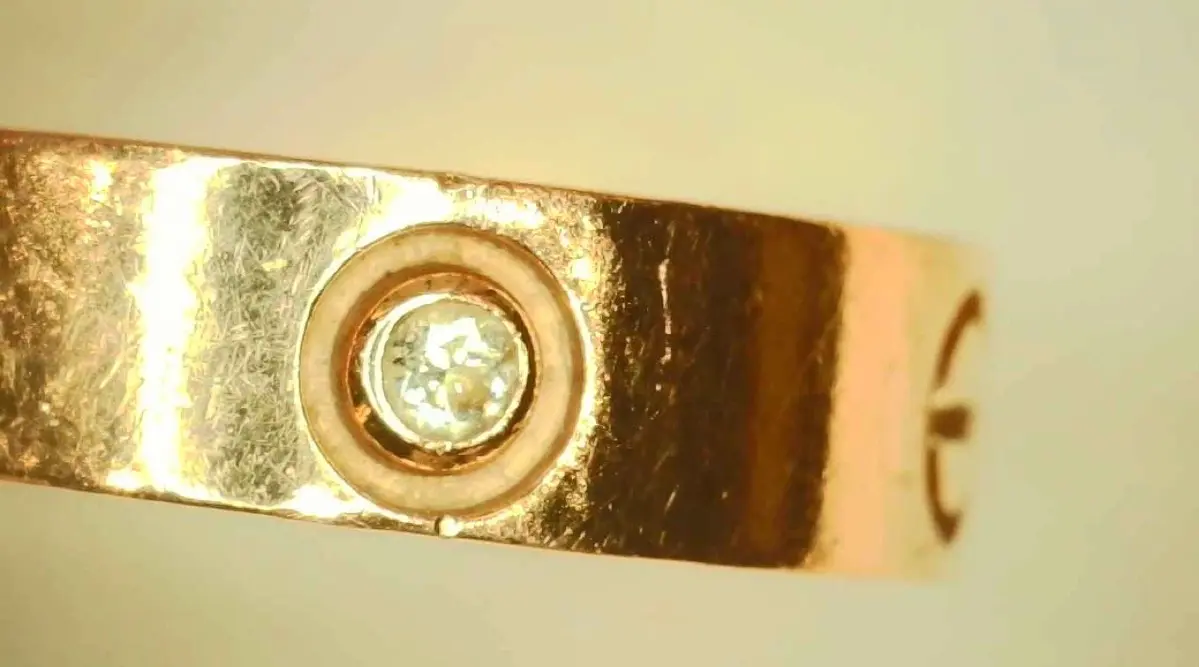 Cartier Love bracelet screw motif and engraving under magnification
