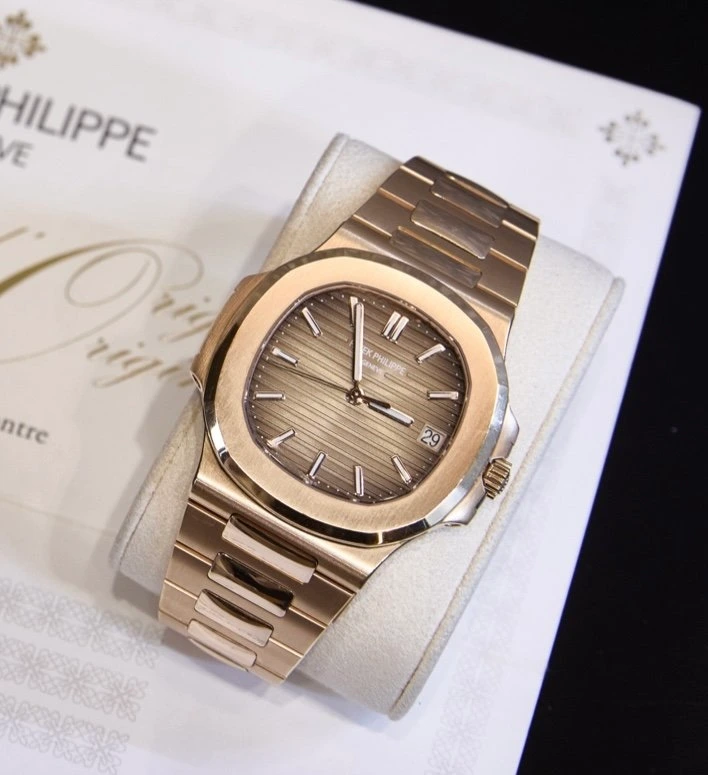 A Patek Philippe Nautilus resting on its certificate of origin during appraisal