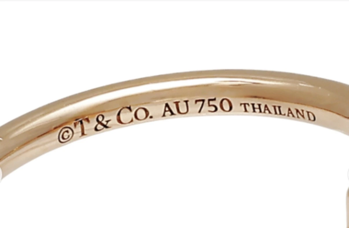 Genuine Tiffany hallmark stamp reading "T & Co. AU 750 THAILAND"