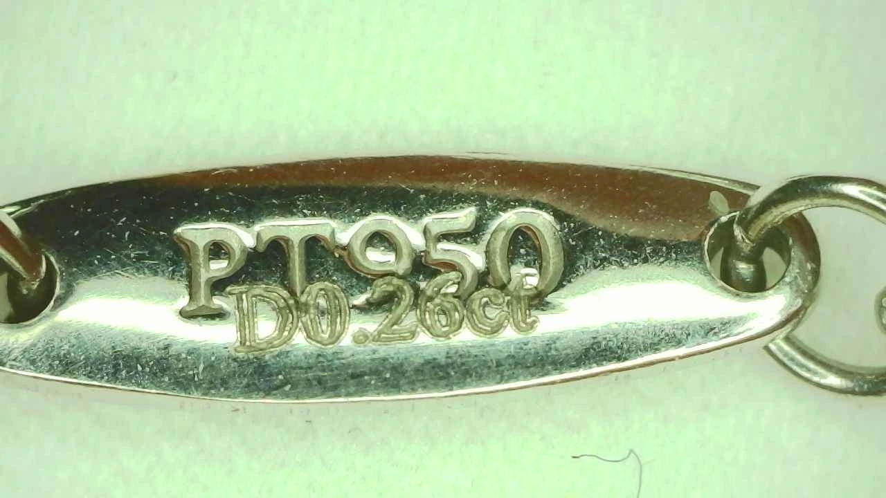 Genuine Tiffany carat-weight engraving reading "PT950 D 0.26CT"