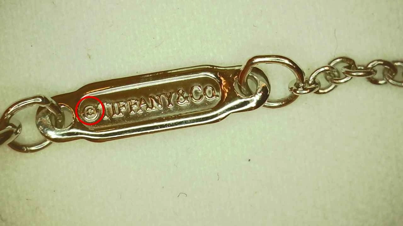 2018 Tiffany Victoria® Pendant (Medium) hallmark tag showing a distorted engraved "C", later confirmed genuine