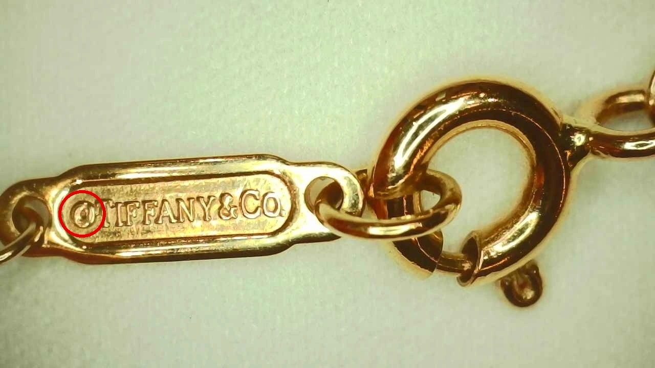 A second 2018 Tiffany Victoria® Pendant (Medium) hallmark tag with the same distorted engraved "C"