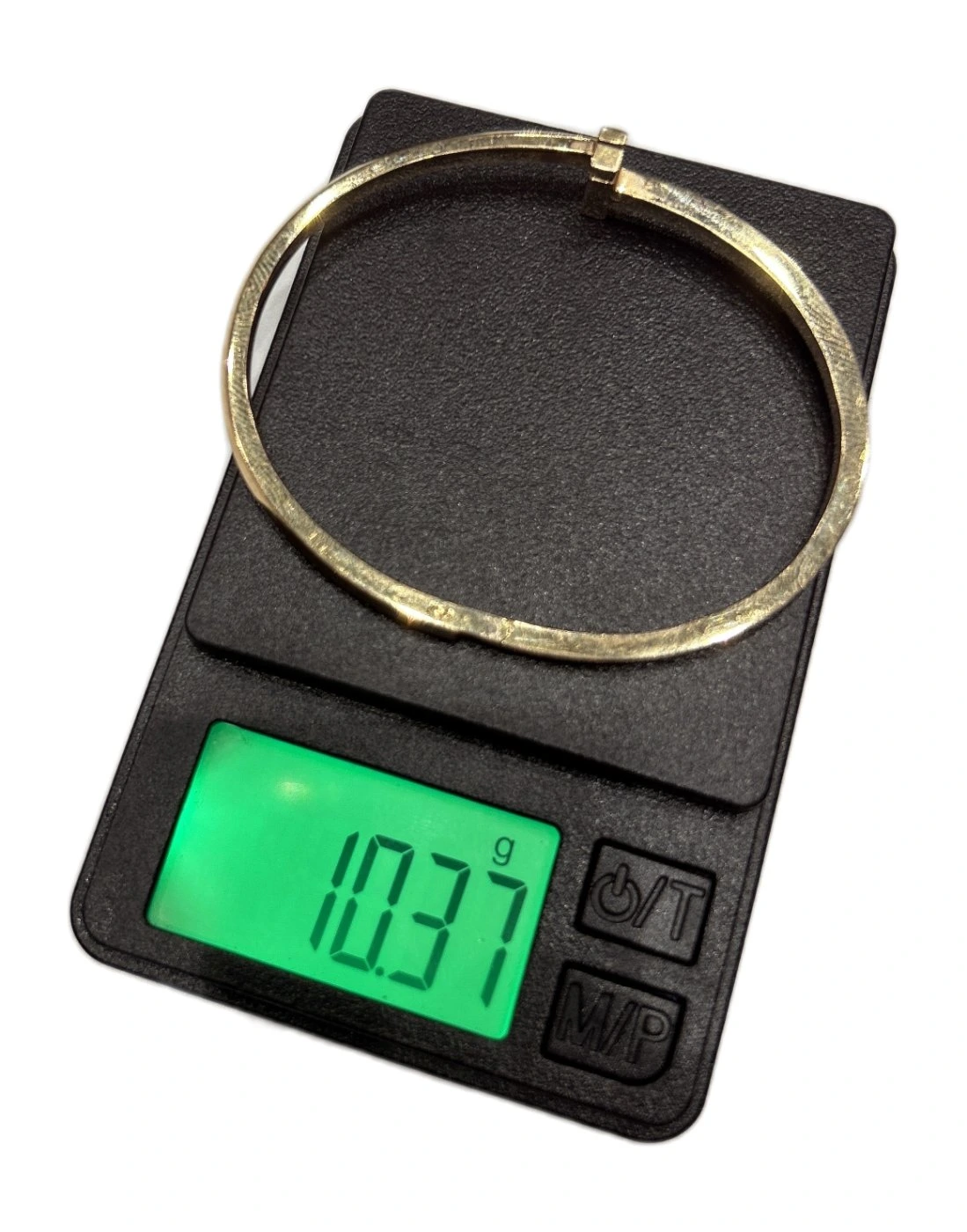 Digital scale reading 10.37 g while weighing a counterfeit Tiffany T1 bangle, well under the genuine ~16g reference weight