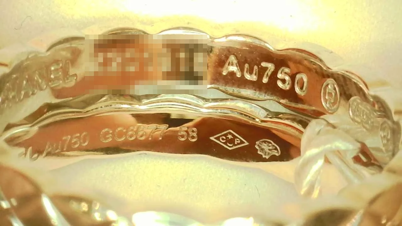 Macro photo of a genuine Chanel Coco Crush Mini ring hallmark engraving, second angle