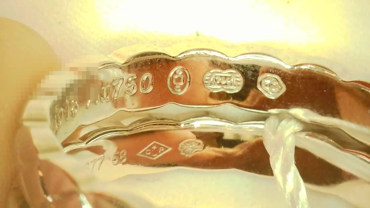 Macro photo of a counterfeit Chanel Coco Crush Mini ring hallmark engraving