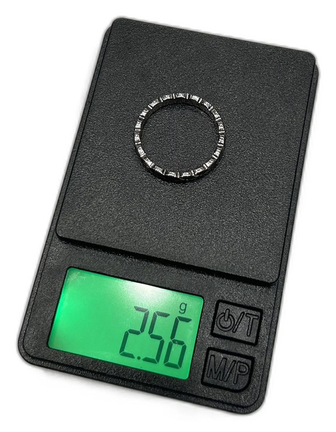 Counterfeit Chanel Coco Crush Mini ring on a jeweler's scale reading 2.56g