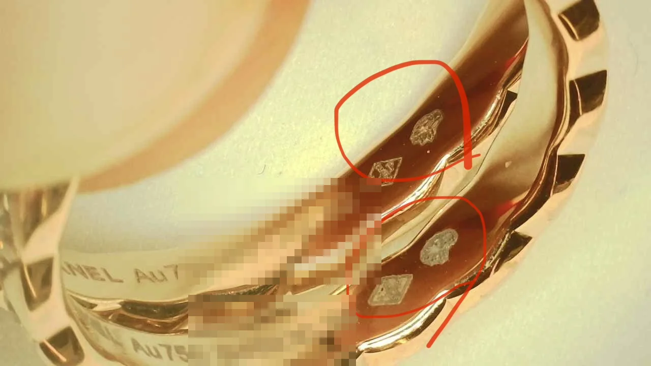 Annotated photo of a counterfeit Chanel Coco Crush Mini band comparing engraving method and eagle's-head hallmark