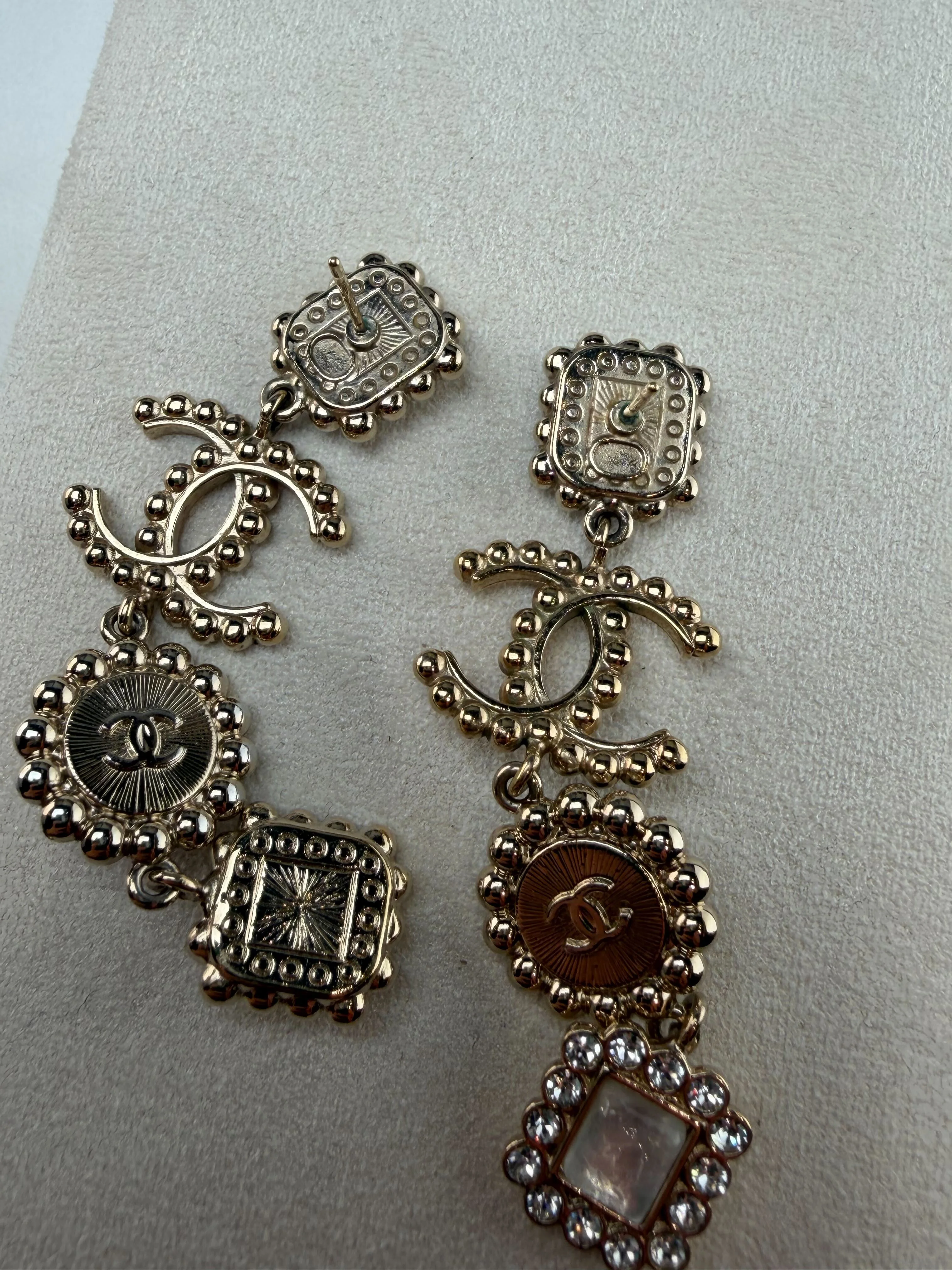 Chanel costume jewelry charm bracelet showing the metal plate stamped with the Chanel logo