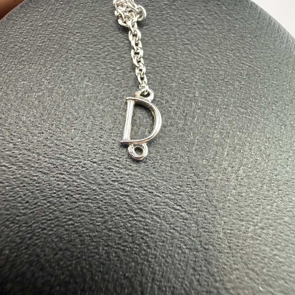 Counterfeit Damiani Belle Époque cross — D ornament at the end of the chain