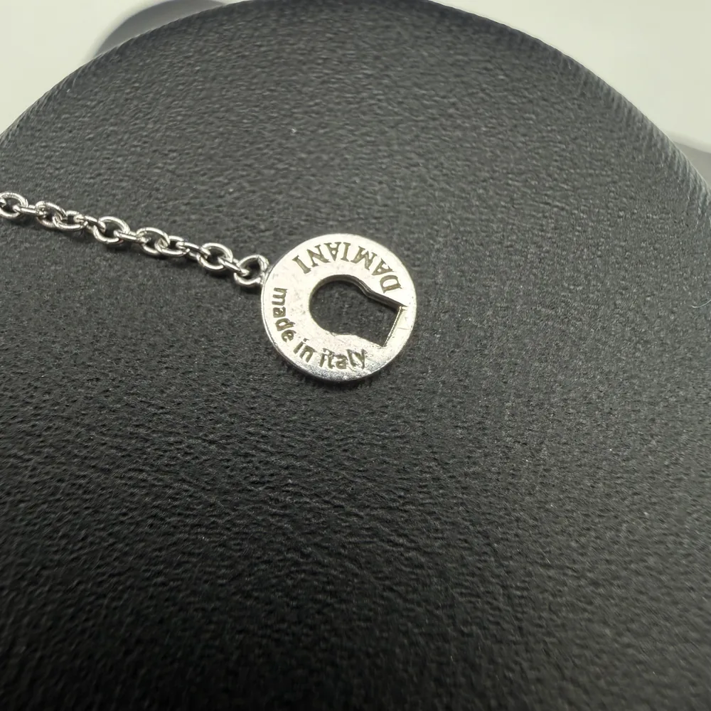 Counterfeit Damiani keyhole tag engraved DAMIANI made in italy