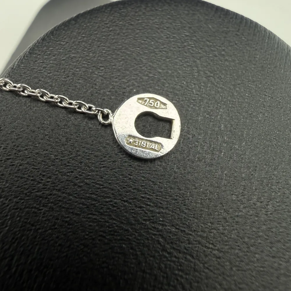 Counterfeit Damiani keyhole tag reverse with 750 and workshop marks