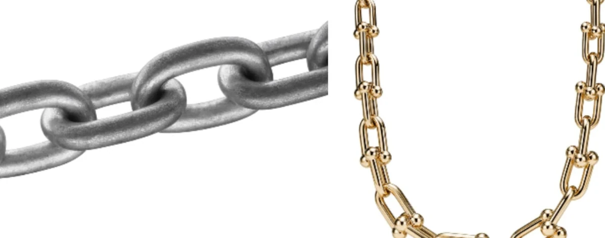 Heavy steel chain links beside the Tiffany HardWear necklace in yellow gold