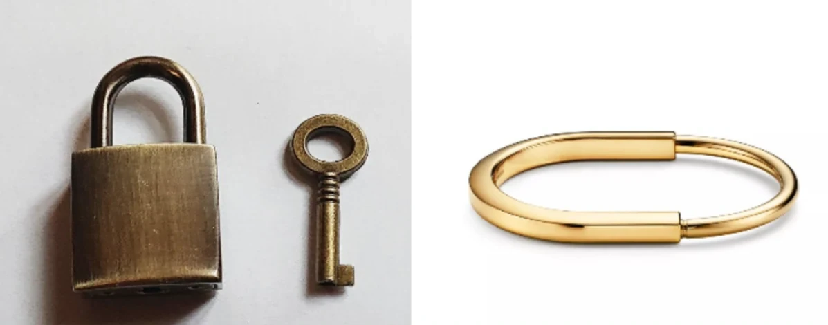 A small padlock and key beside the Tiffany Lock bangle in yellow gold