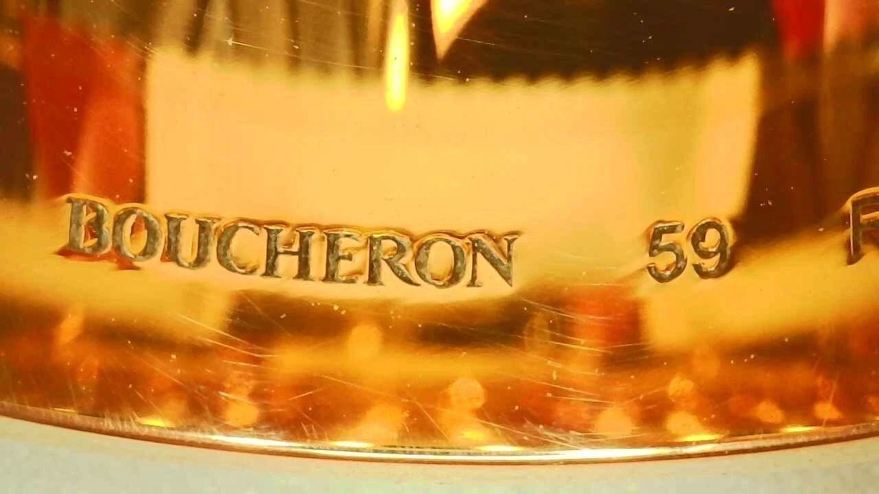 Macro photo of a genuine Boucheron Quatre ring hallmark, engraved "BOUCHERON 59"