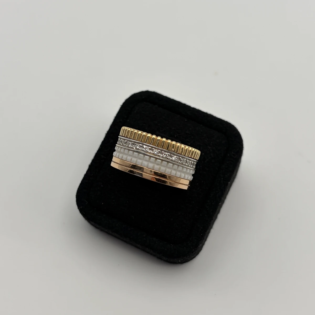 Front view of the Boucheron Quatre Classic ring showing its gold, white ceramic, and diamond bands