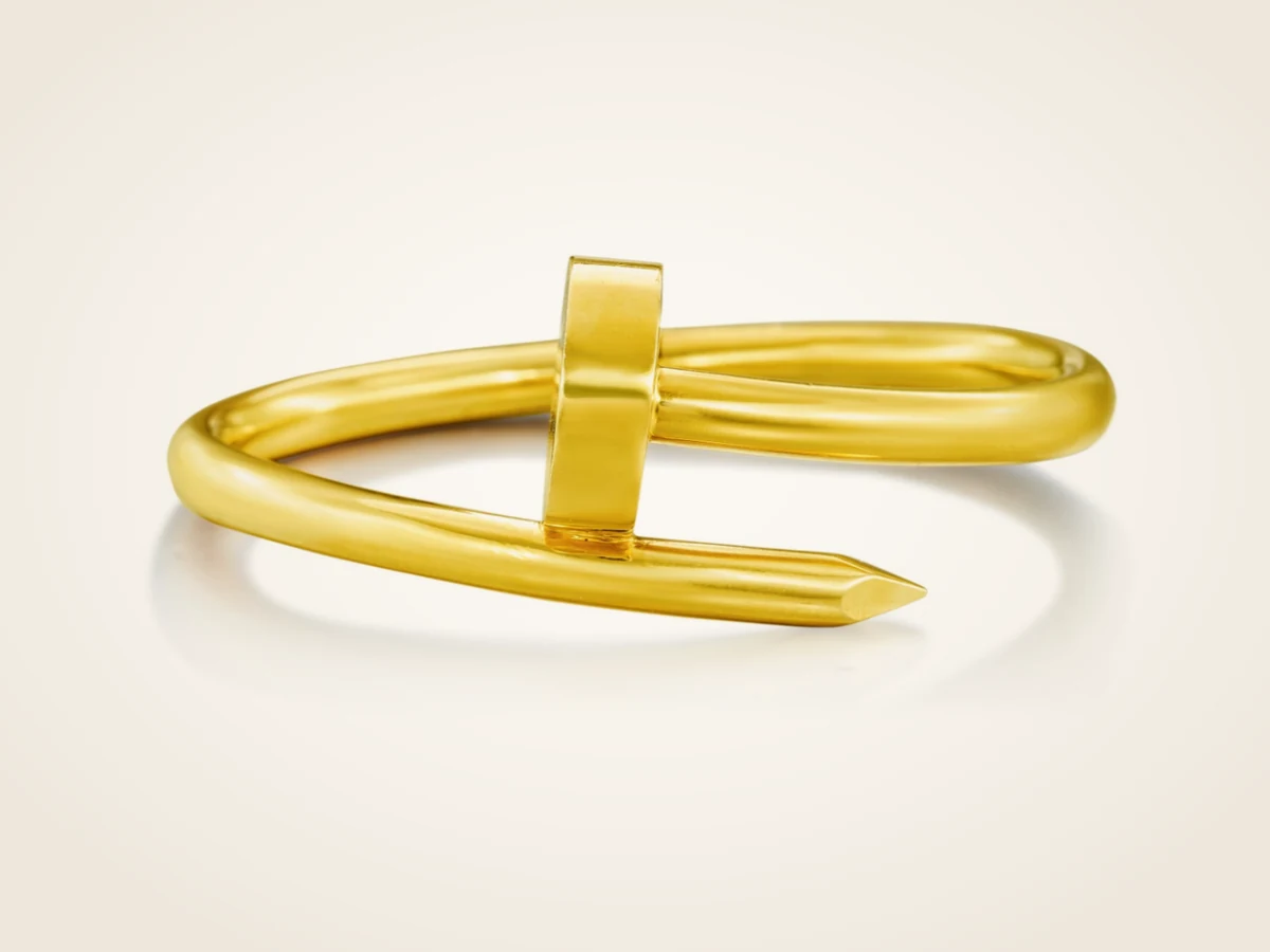 Cartier Juste un Clou bracelet in yellow gold, showing the pointed nail tip wrapping around the band