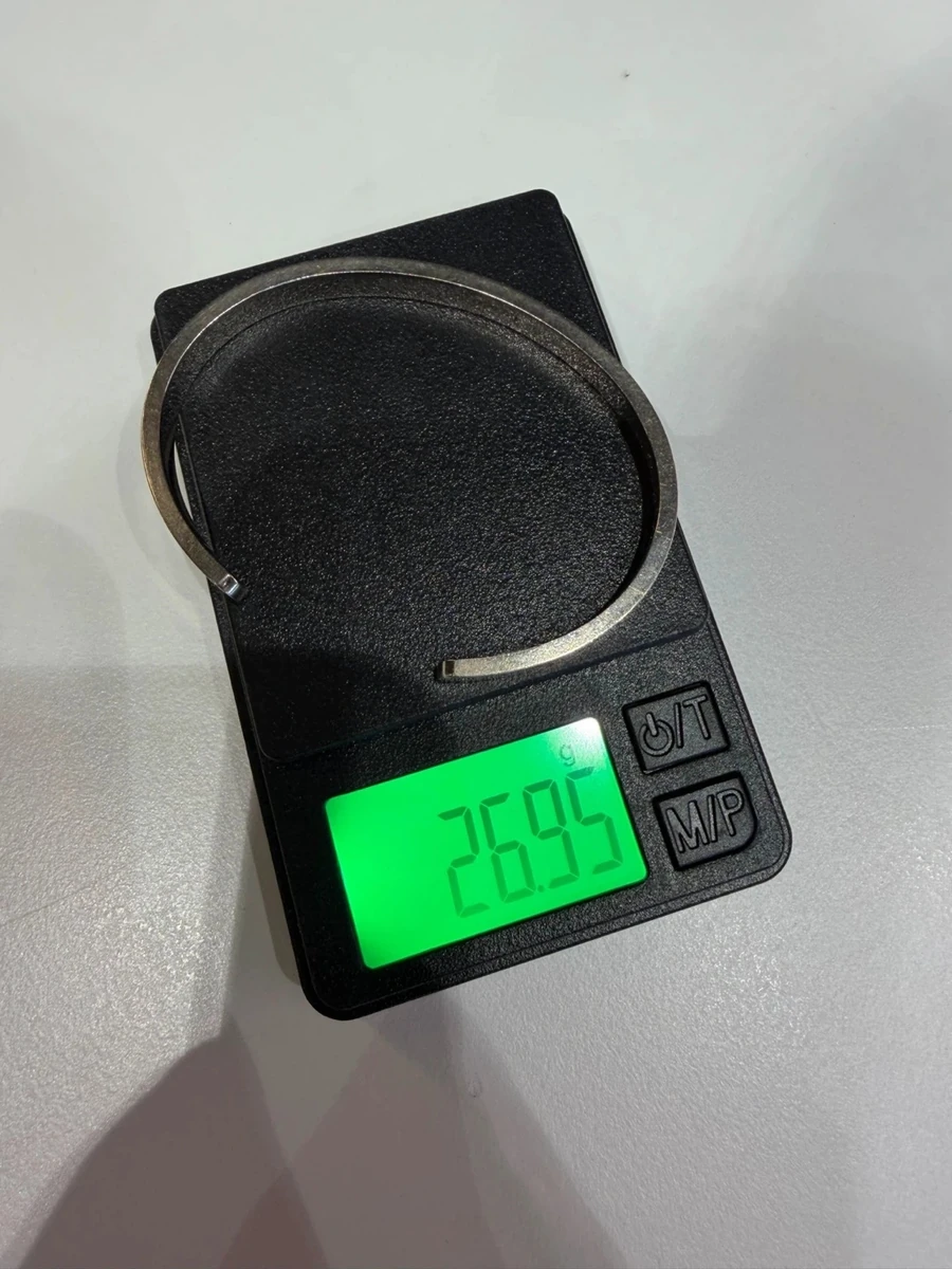 Cartier Love bracelet in white gold on a digital scale before polishing, reading 26.95 g