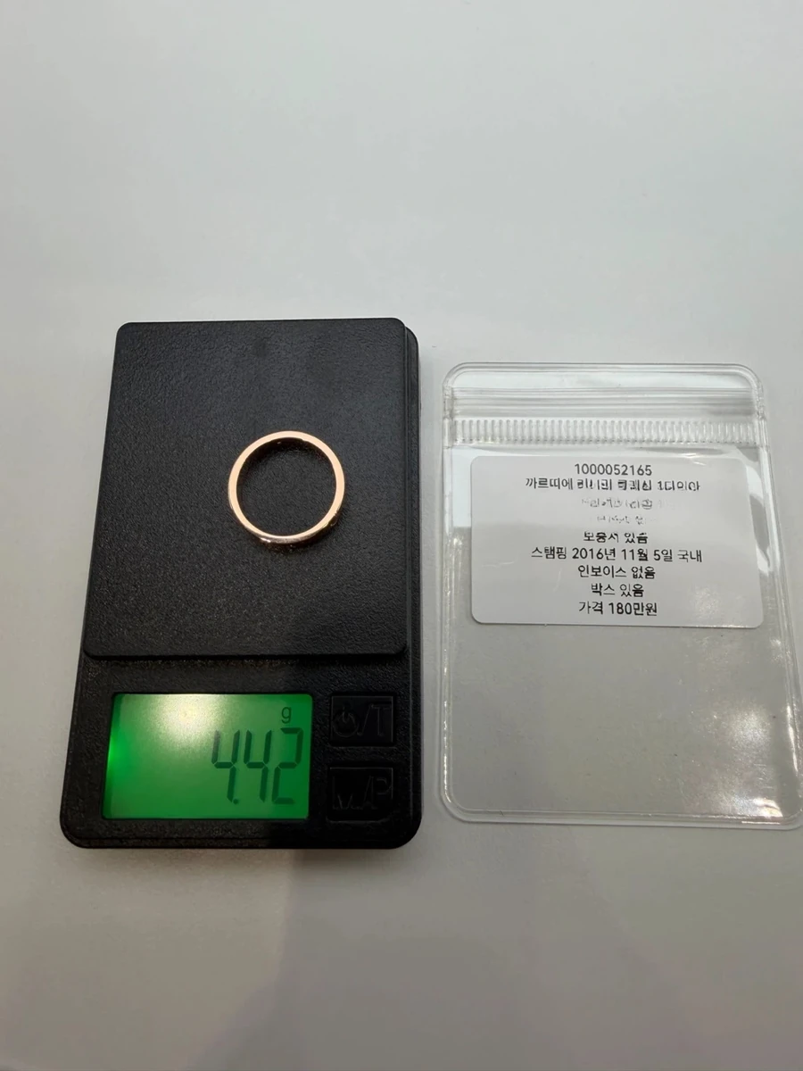Women's Cartier Love ring with one diamond, size 50, on a digital scale after polishing, reading 4.42 g