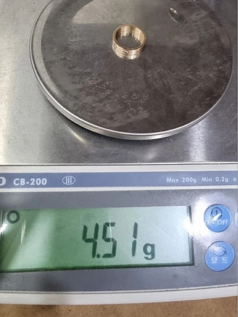 Women's Cartier Love ring with one diamond, size 50, on a precision scale before polishing, reading 4.51 g