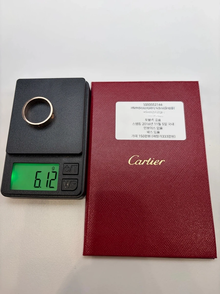 Men's Cartier Love ring, size 57, on a digital scale after polishing, reading 6.12 g