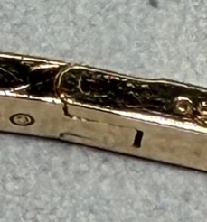 Close-up of a counterfeit Tiffany T1 bangle hinge showing visible play and looseness
